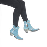 Suede blue botin with studs on a silver overlay of leather.  Botin angled to the right