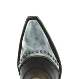 Brass and silver botin with a riding cowboy on the outer par of the shaft and studs. View of the toe