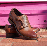 Oxford saddle shoe with floral laser on the vamp. Angled to the right