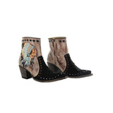 Burnished black botin with an embroideryed apache head on the outside of the boot. 